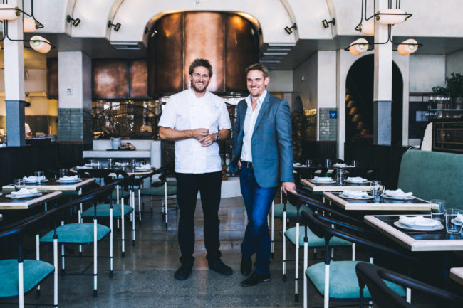 Chef Curtis Stone and Luke Stone pose inside their restaurant, Gwen.